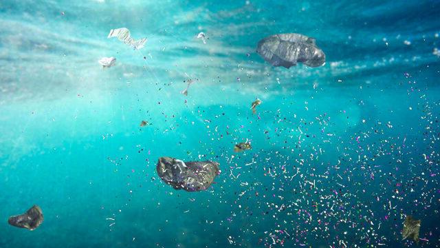 Underwater view of plastic pollution in ocean water and microplastics in the current